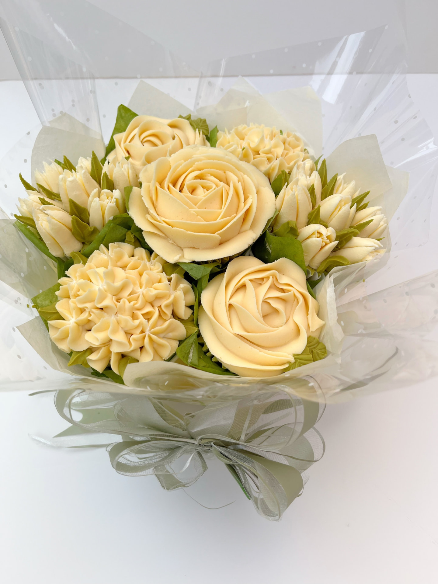 Classic 7-cupcake bouquet in cream buttercream roses and tulips
