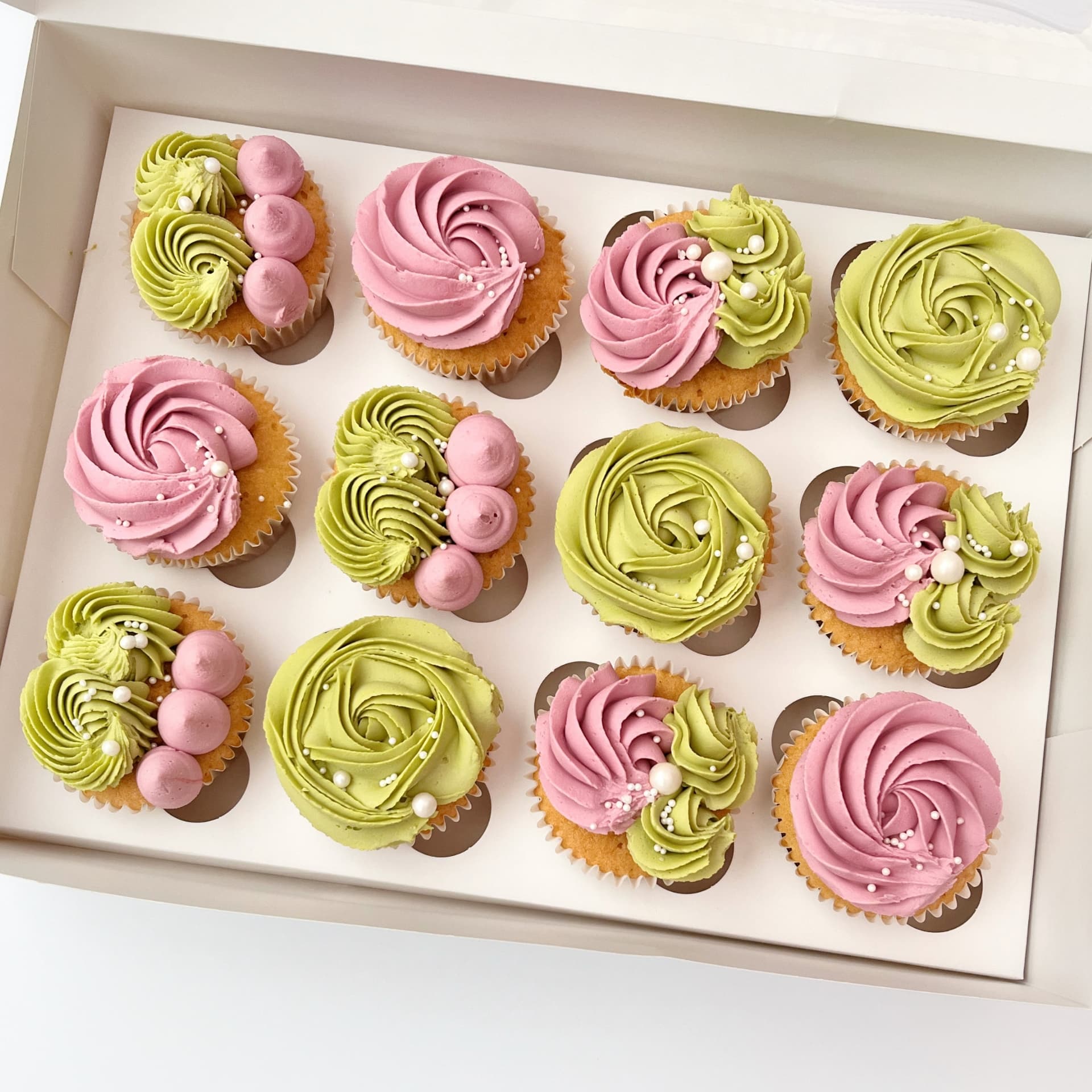 Box of twelve pink and soft green buttercream swirl cupcakes