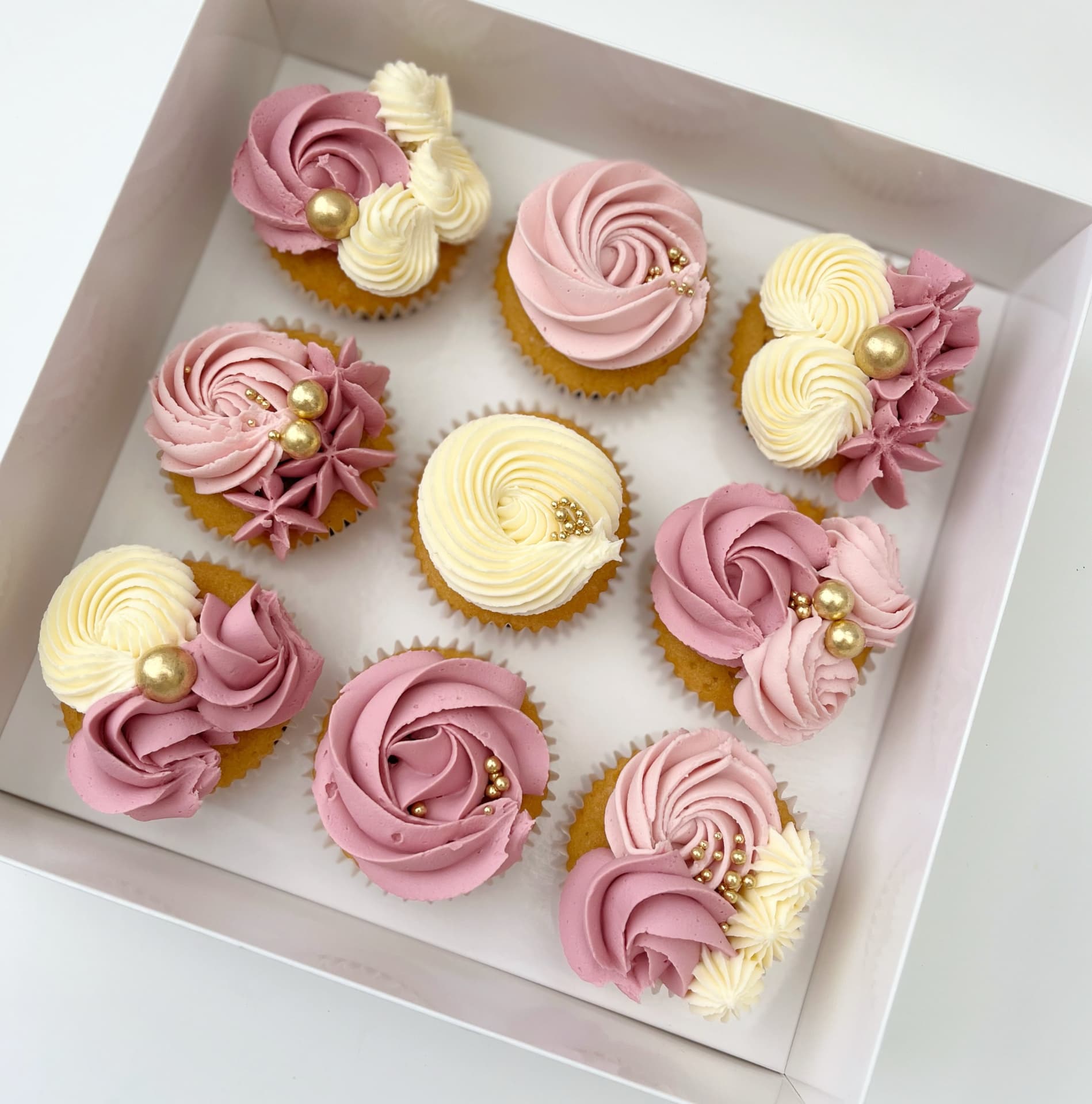 Box of nine dusky pink and cream cupcakes with gold pearls