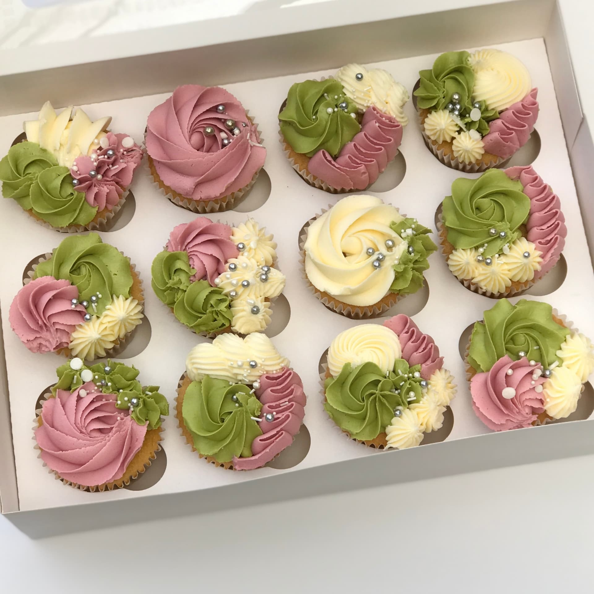 Box of twelve dusky pink, green and cream swirl cupcakes