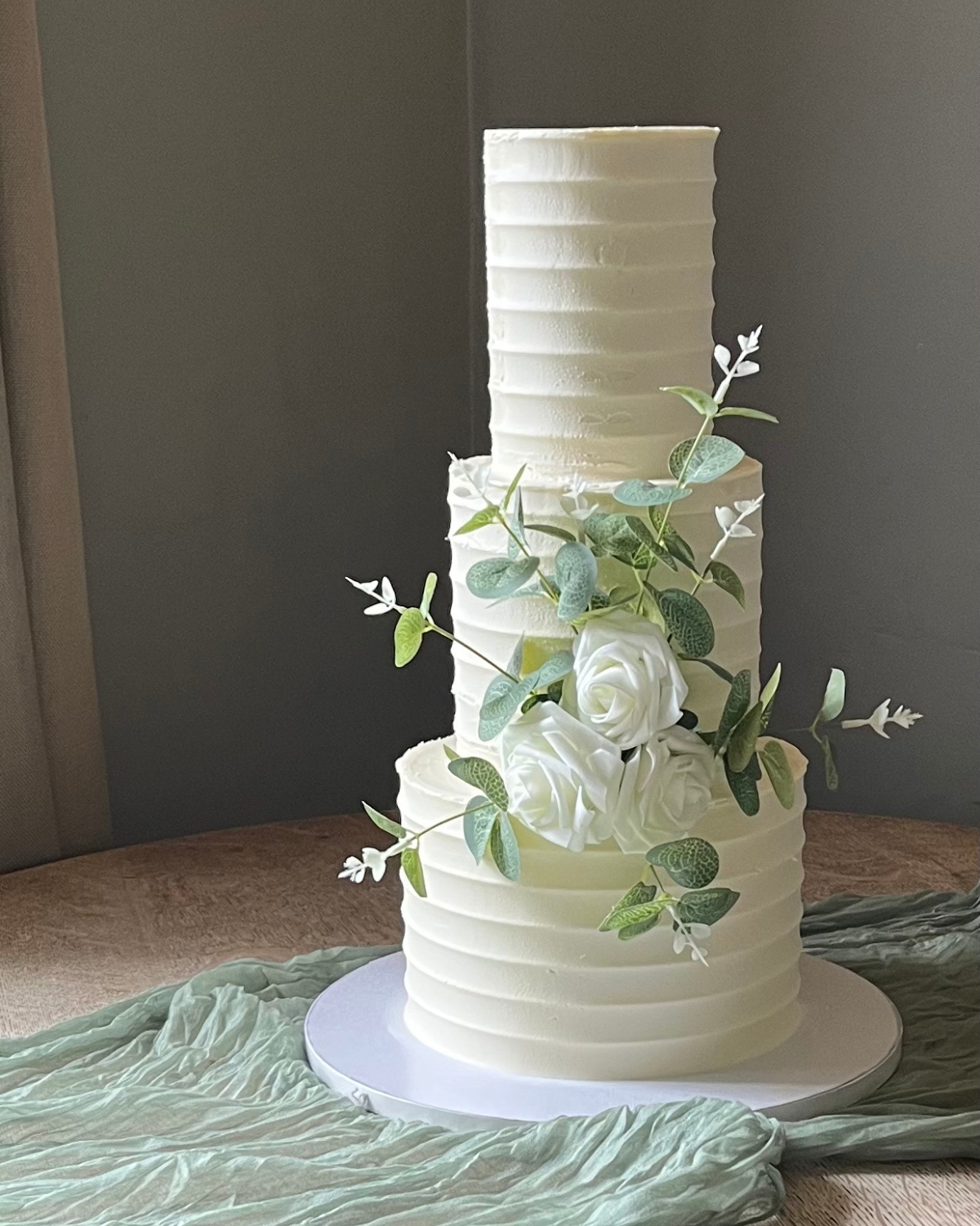 Elegant multi-tier wedding cake with delicate floral detail