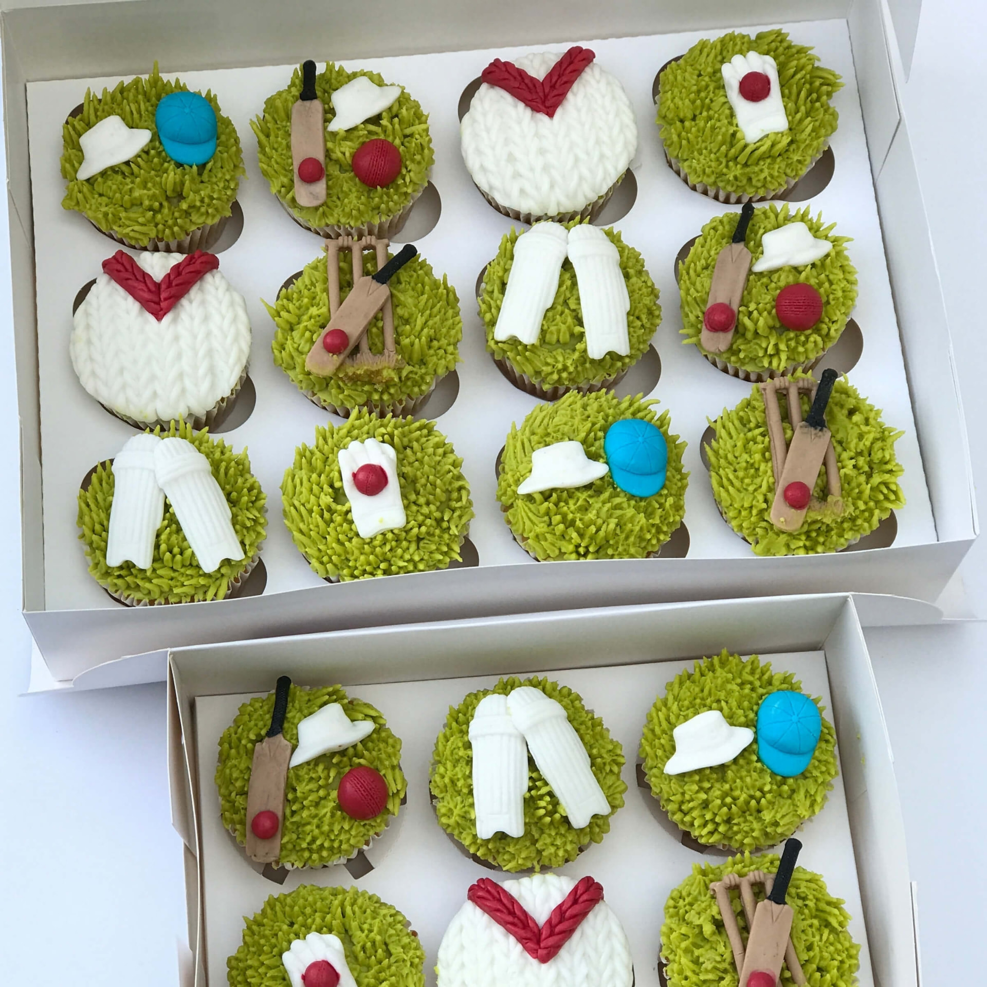 Cricket themed cupcakes with sugar bats, balls, pads and jumpers