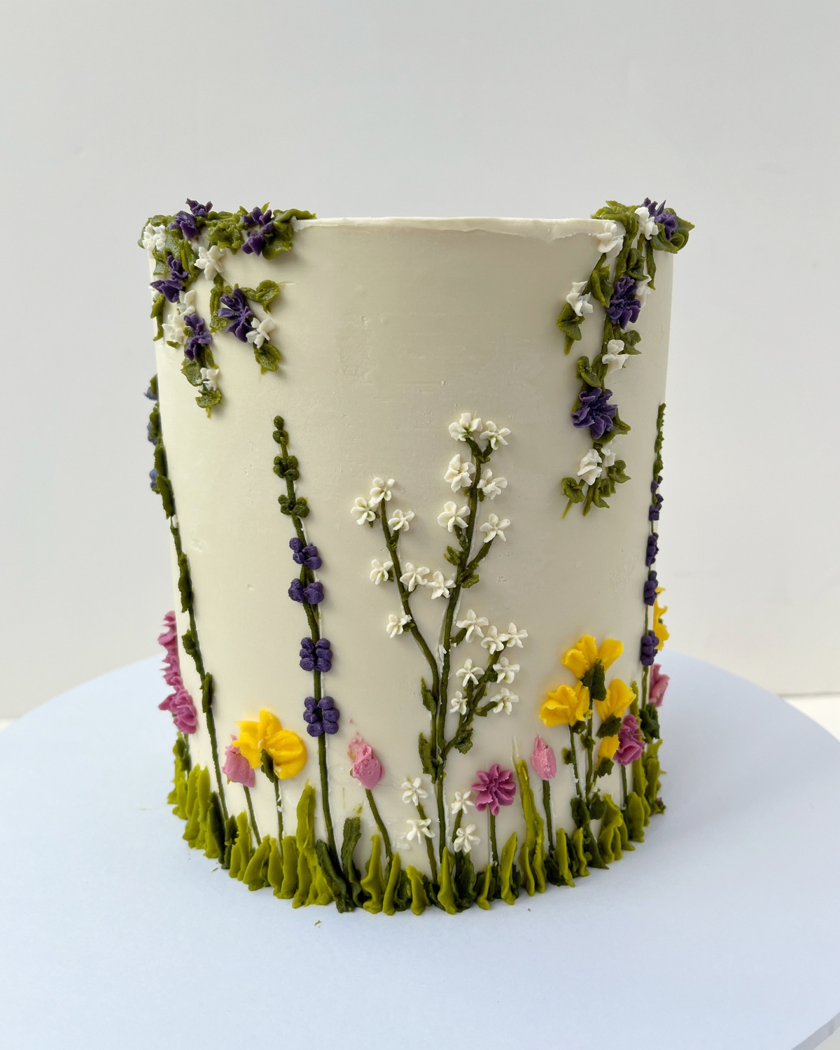 Wildflower celebration cake with hand-piped buttercream meadow flowers
