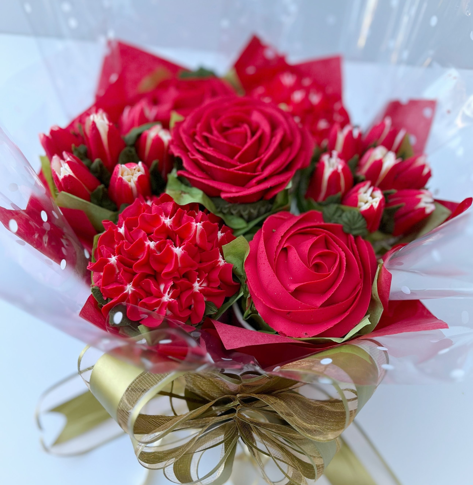 Classic 7-cupcake bouquet in red buttercream roses with gold ribbon